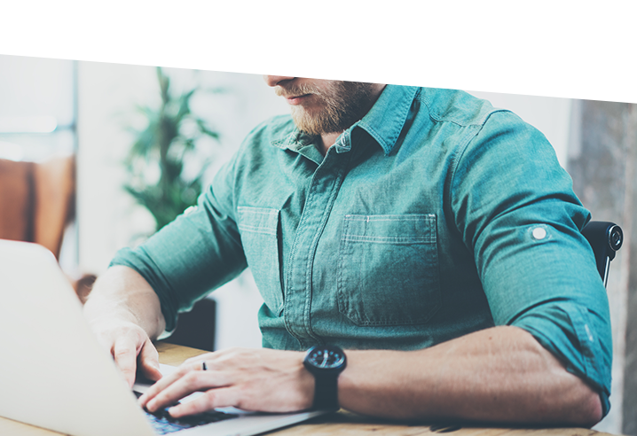 man calculating profits and running reports on laptop